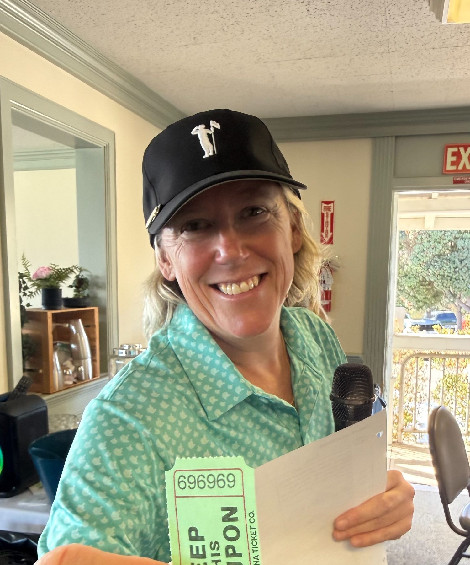 Raffle emcee Julie Workman calls out the winning numbers, helping make the Monarch Invitational's fundraising efforts such a success.