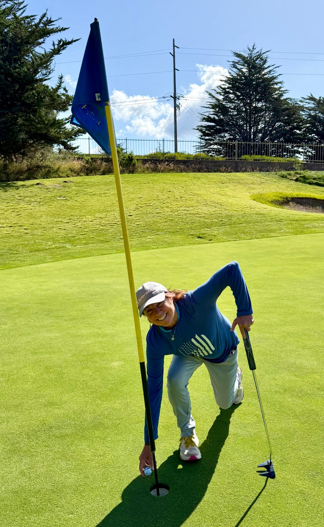 Louise Booth with hole-in-one ball at Cypress Ridge Golf Course.